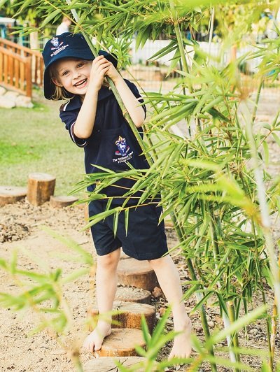 Early learner plays among the bamboo