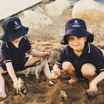 Two students playing in sandpit